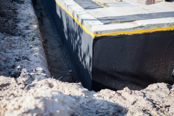 Professional Basement Waterproofing technician working in Harrisburg, OH